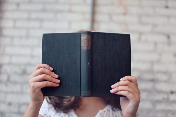 Life-Changing Lessons From 9 Awesome Real Estate Books Person reading a book