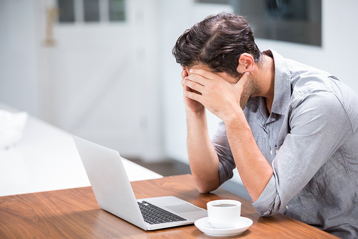 3 House Hacking Mistakes I Made (& How I Could’ve Prevented Them) Tensed young man with head in hands