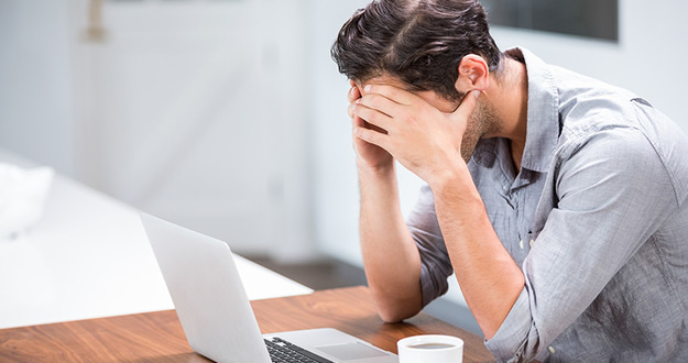 3 House Hacking Mistakes I Made (& How I Could’ve Prevented Them) Tensed young man with head in hands