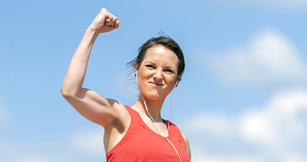 30-Second Trick to Double Your Success in Real Estate Investing woman with victorious fist in air signifying accomplishment