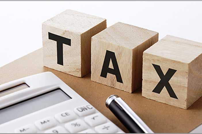 Should You Fire Your CPA? letters taxes on wooden blocks with calculator and pen