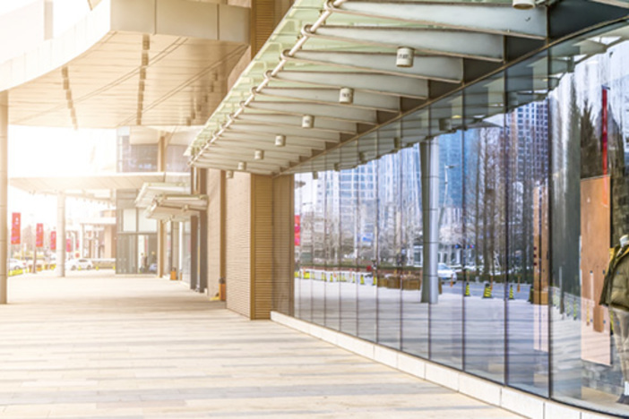 4 Major Commercial Investing Strategies Explained strip mall with clothing storefront in view