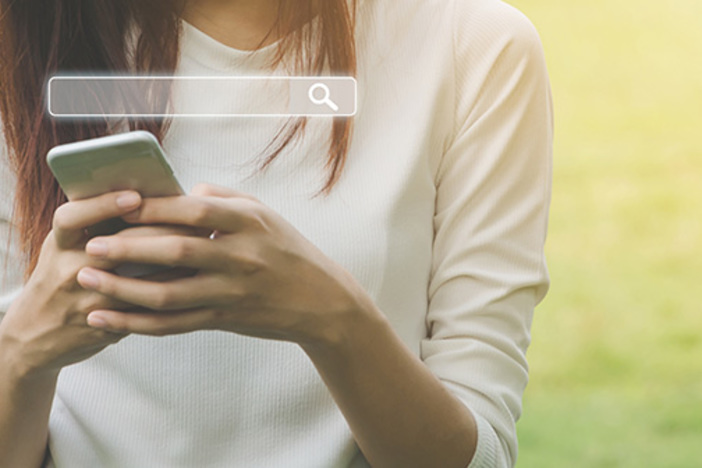 How to Drastically Increase Real Estate Lead Generation (From the Comfort of Your Desk Chair!) Woman uses a smartphone to find what you are interested. Searching information data on internet networking concept