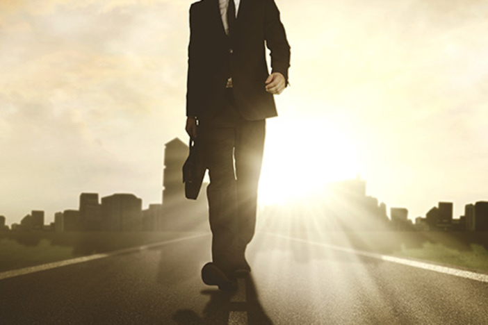 How to Be a Successful Investor When You Know Nothing About Real Estate Low angle view of a young male manager carrying a briefcase while walking on the road with skyscraper background