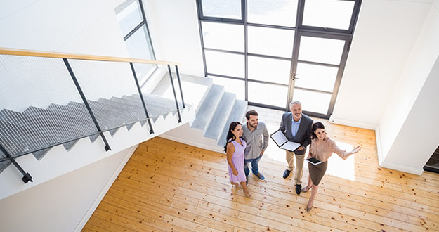 Why More Seniors Are Turning to Real Estate Sales Later in Life real estate agent giving a home tour to clients