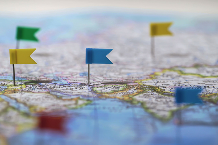 3 Things to Consider When Buying Properties Internationally Locations marked with pins on world map, global communication network, closeup