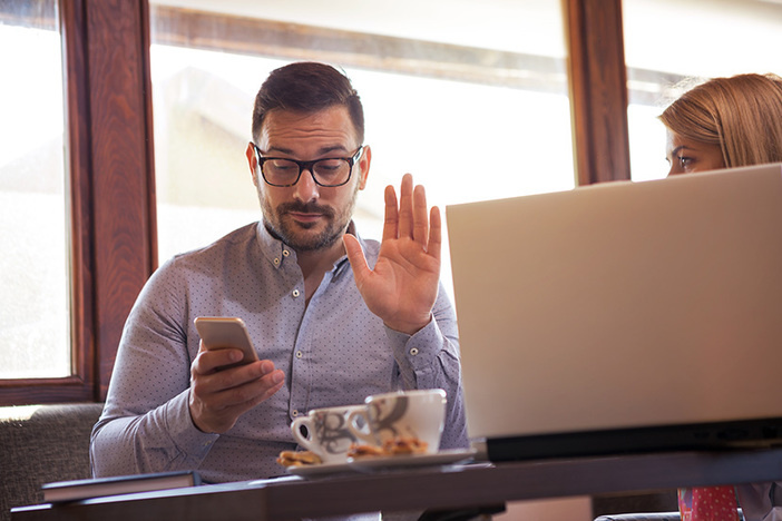 Borrower Beware: Not All ‘Private Money Lenders’ Are Created Equal A handsome young businessman tries to call the boss over the phone while sitting with his colleague in front of a laptop.