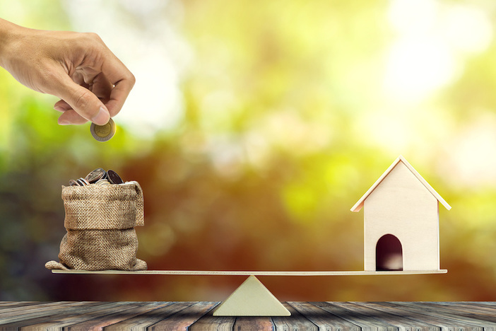 The Beginner’s Guide to BRRRR Financing with Other People’s Money Real estate investment, home loan, reverse mortgage, savings to buy home concepts. House wood model, Hand putting coin into a bags on wood balance scale. depicts a funding for real estate investment.