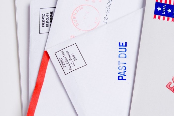 7 Undeniable Reasons Online Rent Collection Beats Paper Checks Small group of envelopes marked "PAST DUE" and "FORECLOSED". Suggesting tough economic times US.