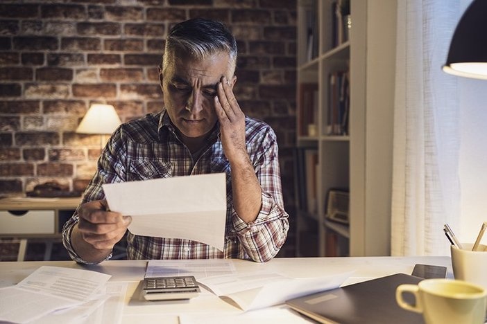 Got Gains? Try This Creative Tax Strategy to Offset Big Profits Worried mature man checking his domestic bills at home, he is concerned and reading his financial statements