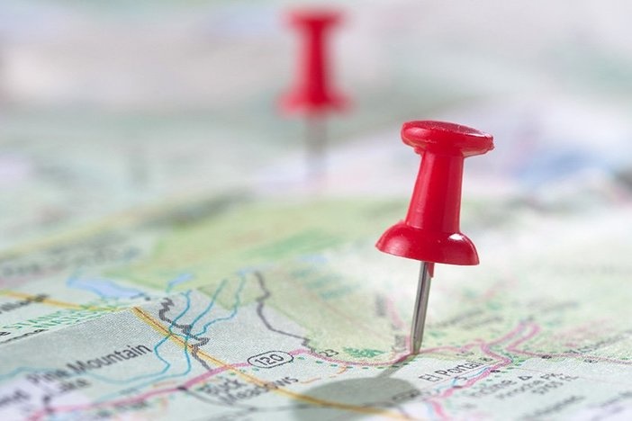 Long-Distance Investing: How to Work on Your Business Instead of in It Travel concept with red pushpin