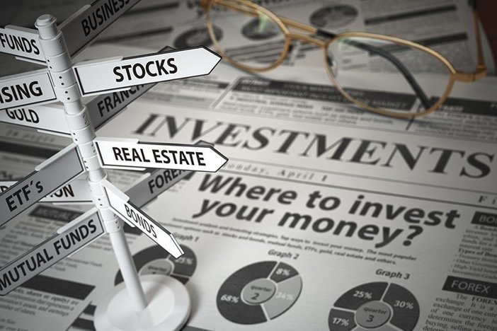 Survey Says: These Are the Best & Worst Investments for 2021 Investmments and asset allocation concept. Where to Invest? Newspaper and direction sign with investment options