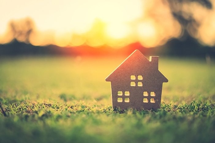 Meet the Investors: I Sold My Wife on House Hacking With a PowerPoint (& Soon We’ll Live for Free!) Featuring Joaquín Camarasa Small model home on green grass with sunlight abstract background. Vintage tone filter effect color style.