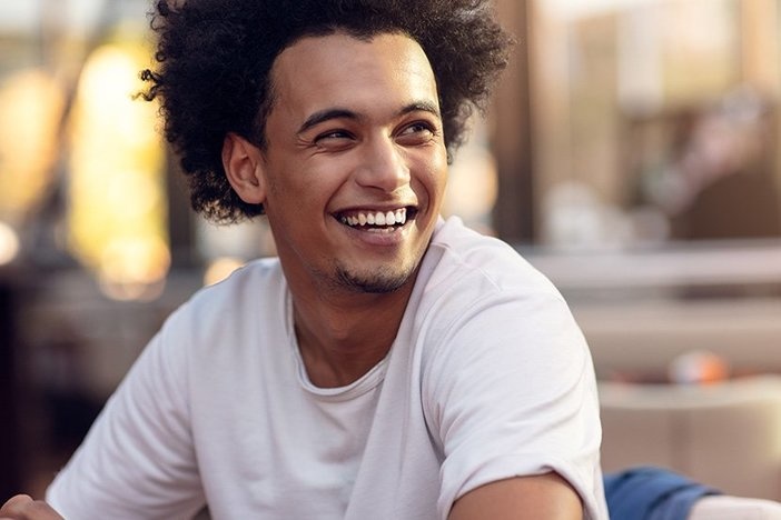 Newbie Agent 101: How to Choose a Real Estate Brokerage Close up portrait of handsome cheerful african man smiling looking at camera