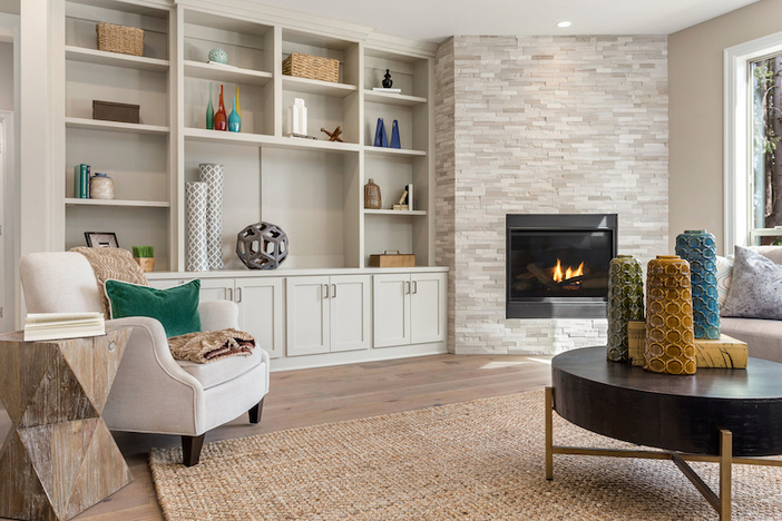Flipping Houses 101: How to Stage a Home to Sell Beautiful Furnished Living Room Interior in New Home with Furniture and Fireplace