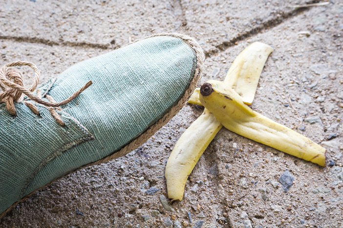 The Rookie Landlording Mistake Most New Investors Make light turquoise canvas shoe about to step on banana peel on sidewalk