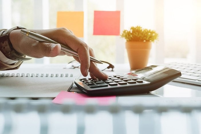How to Calculate Cash-on-Cash Return (Made Easy!) Close up view of bookkeeper or financial inspector hands making report, calculating or checking balance. Home finances, investment, economy, saving money or insurance concept