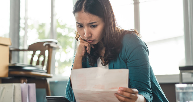 7 Toxic Money Habits That Harm Your Financial Future Asian women worry about monthly expense and credit card debt.